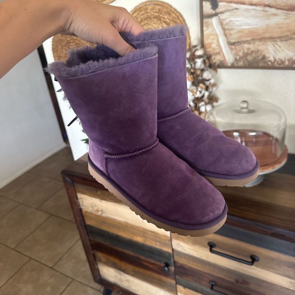 Purple UGG boots with bows